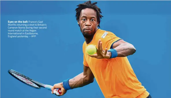  ??  ?? Eyes on the ball: France’s Gael Monfils returning a shot to Britain’s Cameron Norrie during their second round match at the Aegon Internatio­nal in Eastbourne, England yesterday. – AFP