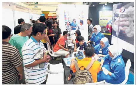  ??  ?? Taking no chances: Visitors getting their blood pressure checked at the KPJ Hospital booths during the expo.