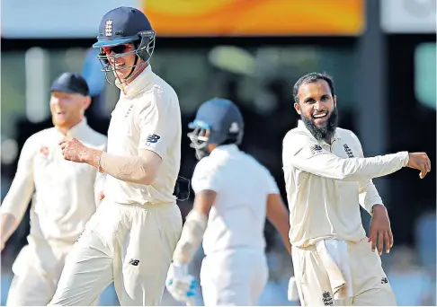  ??  ?? Dominant: Keaton Jennings (front left) along with bowler Adil Rashid (right) celebrate the dismissal of Sri Lanka’s Roshen Silva during the second day of the third Test