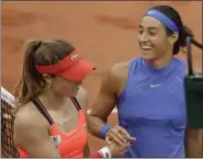  ?? PETR DAVID JOSEK — THE ASSOCIATED PRESS ?? France’s Caroline Garcia, right, smiles to compatriot Alize Cornet after she won their fourth round match of the French Open at Roland Garros stadium, in Paris, France on June 5.