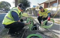  ?? /Reuters ?? Hi-tech: Workers arrange fibreoptic cables used in the National Broadband Network in west Sydney in 2013.