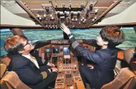  ?? PROVIDED TO CHINA DAILY ?? Women pilots Guo Hui (right) and Heather Ross in the cockpit of an Air China plane in Beijing.