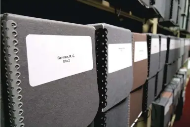  ??  ?? Boxes filled with R.C. Gorman materials line a shelf at the Heard Museum's library.