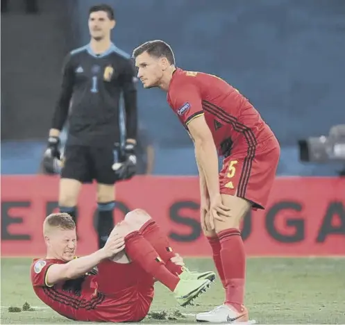  ??  ?? 0 Belgium midfielder Kevin De Bruyne writhes in pain after suffering an ankle injury during Sunday’s last-16 win against Portugal