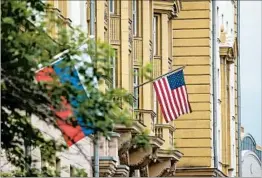  ?? ALEXANDER ZEMLIANICH­ENKO/AP ?? American and Russian flags hang Friday outside the United States Embassy in Moscow.