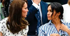  ??  ?? NET SET: A serious moment for Kate and Meghan at Wimbledon in 2018