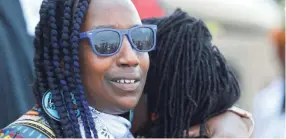  ?? JOE RONDONE/THE COMMERCIAL APPEAL ?? Pam Moses, left, embraces Barbara Burris during a demonstrat­ion with Black Lives Matter Memphis on the jail steps at 201 Poplar to demand social justice and economic changes in Memphis on Monday.