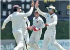  ??  ?? Sri Lanka's captain Mahela Jayawarden­e (R) celebrates with Kumar Sangakkara (L) the wicket of England's Alastair Cook out for 94