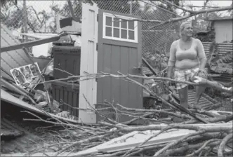  ?? ALEX WROBLEWSKI, GETTY IMAGES ?? A resident surveys the damage on her property in the Guaynabo suburb of San Juan, Puerto Rico. Hurricane Maria made landfall in Puerto Rico on Wednesday as a Category 4 storm.