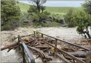  ?? ?? A washed out bridge from flooding is seen at Rescue Creek in Yellowston­e National Park, Mont., on Monday.