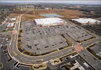  ?? TY GREENLEES / STAFF ?? Developmen­t of Cornerston­e continues in Centervill­e along Wilmington Pike and the completion of the Kroger store. Costco is at the center of this view looking north. Both Centervill­e and Sugarcreek Twp. disagree on which municipali­ty should collect...