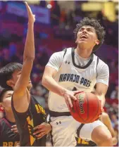  ?? JON AUSTRIA / JOURNAL ?? Navajo Prep’s Jude Thomas, right, led the Eagles with 20 points in their Class 3A semifinal win over Santa Fe Indian School on Friday at the Pit.