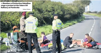  ?? Robert Melen ?? > Members of Extinction Rebellion stage a protest at the Valero Oil Refinery at Pembroke