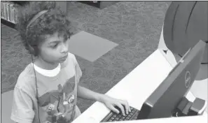  ?? The Sentinel- Record/ Richard Rasmussen ?? PLUGGED IN: Hot Springs resident Christian Saffold works on a computer Monday in the children’s section of the Garland County Library. A variety of databases and services for students are accessible through the library’s website.