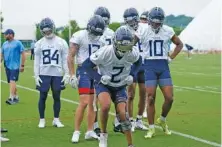  ?? AP PHOTO BY MARK HUMPHREY ?? Tennessee Titans wide receiver Robert Woods (2) takes part in a drill on May 24 in Nashville. Woods, traded to the Titans in March by the Los Angeles Rams, is one of several Tennessee players working to return from injury this offseason.