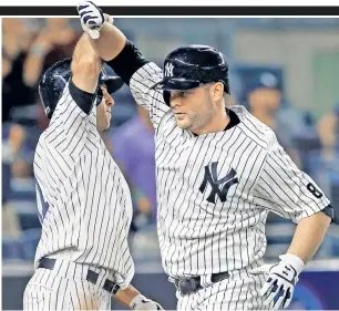  ??  ?? LIFE OF BRIAN: Brian McCann (right) celebrates with Brett Gardner after hitting his game-tying, three-run homer in the ninth inning of the Yankees’ 9-7 win.