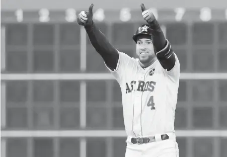  ??  ?? Astros outfielder George Springer celebrates a run-scoring double during the first inning of Game 3.