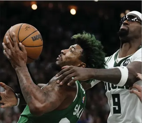  ?? AP ?? NOT SO FAST: Milwaukee’s Bobby Portis fouls Marcus Smart during the second half of Game 3 of their series with the Celtics. The Bucks won 103-101 to take a 2-1 lead in the series.