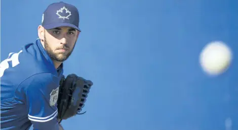  ?? NATHAN DENETTE/CP ?? Toronto pitcher Marco Estrada throws a bullpen session during baseball spring training in Dunedin, Fla.