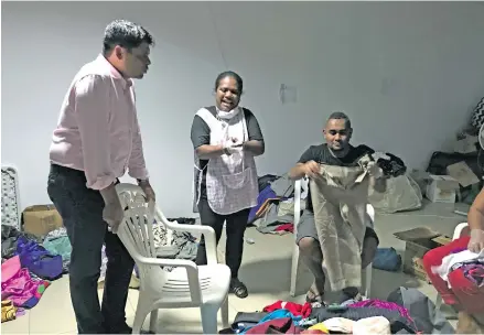  ?? Photo: Ashna Kumar ?? Attorney-General Aiyaz Sayed-Khaiyum with staff from the Ministry of Justice, his office and Solicitor-General’s office going through the stock pile of clothes on April 7th. 2018.