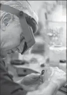  ??  ?? Synowicki Jewel Box's master jeweler Brain Synowicki polishes a pendant at his store on Wednesday.