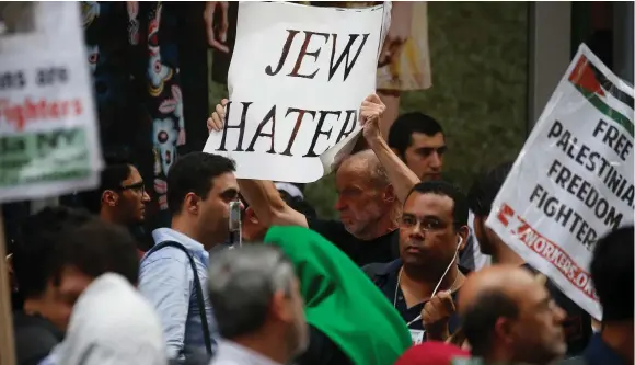  ??  ?? A PRO-ISRAEL activist carries a sign accusing Muslim demonstrat­ors of being ‘Jew haters’ during a demonstrat­ion in Times Square in Manhattan in June.