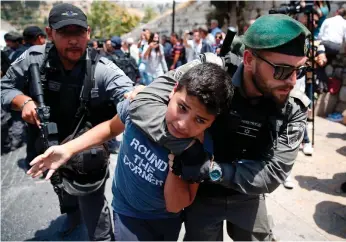  ?? AFP ?? Israeli border guards detain a Palestinia­n youth near the Al Aqsa Mosque during protests against new security measures by Israeli authoritie­s, including metal detectors