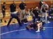  ?? JOHN KAMPF — THE NEWS-HERALD ?? The Riverside corner watches the 113-pound championsh­ip match between Riverside’s Chris Rocha and Chardon’s Jake Hamulak at the Western Reserve Conference tournament on Feb. 9 in Madison.