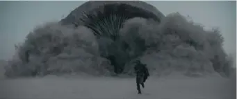  ?? ?? SPICE WORLD: Paul Atreides (Timothee Chalamet) runs from a sandworm in the deserts of ‘Dune.’