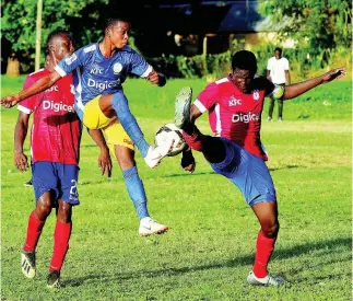  ??  ?? Hydel High’s Delroy Trowers (centre) brings the ball down while under pressure from Camperdown High’s Cafu Washington (left) and Jeovanni Laing during their ISSA/Digicel Manning Cup game at the Caymanas Field on Friday, September 13.