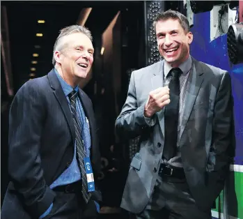  ?? GETTY IMAGES ?? Canucks team physician Dr. Jim Bovard, left, shares a laugh with Rick Celebrini, the NHL team’s former director of rehabilita­tion who is about to join the Golden State Warriors of the NBA.