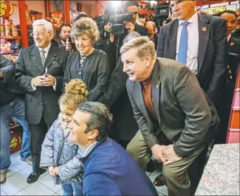  ?? Andrew Rush/Post-Gazette ?? Republican candidate Rick Saccone, right, campaigns with Donald Trump Jr. on Monday at Sarris Candies in Canonsburg.