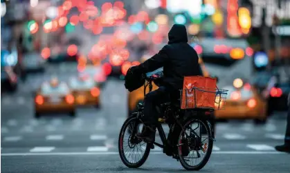  ?? ?? Delivery workers say app algorithms create incentives to deliver faster without regard for traffic rules. Photograph: Johannes Eisele/AFP/ Getty Images