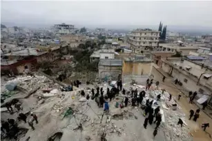  ?? ?? Rescuers prepare to search for survivors in the rebe l- he ld town of Jandaris, Syria (Reuters)