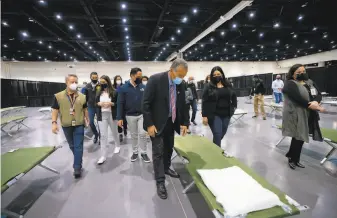  ?? Nelvin C. Cepeda / San Diego Union-Tribune ?? Rep. Juan Vargas, DSan Diego, tours an area Saturday of the San Diego Convention Center where migrant girls will be sheltered. The Biden administra­tion is boosting shelter capacity.