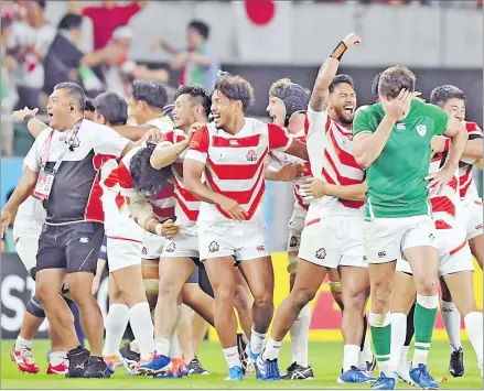  ?? Picture: NIKKEI ASIAN REVIEW ?? Japan players celebrate after defeating Ireland in their pool match.