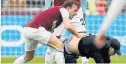  ??  ?? SHAME Mark Noble grapples with a fan