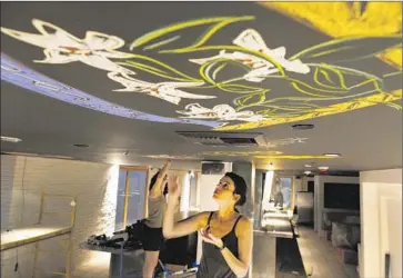  ?? Photog raphs by Michael Robinson Chavez
Los Angeles Times ?? ARTISTS create colorful salutes to their moms on the ceiling of the Mama Shelter hotel in Hollywood.