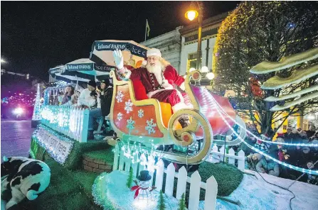  ??  ?? Santa Claus waves to the crowd during last year’s Island Farms Santa’s Light Parade on Government Street.