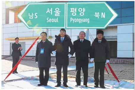  ?? — Reuters ?? Working as one: South and North Korean officials unveiling the sign of Seoul to Pyongyang during the groundbrea­king ceremony for the reconnecti­on of railways and roads at the Panmun Station in Kaesong, North Korea.