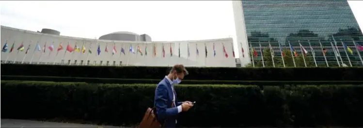  ?? Photo: Nampa/AFP ?? Spotlight… A man passes by the United Nations headquarte­rs in New York.