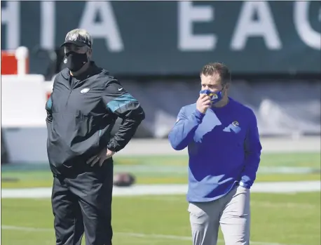  ?? CHRIS SZAGOLA - FOR THE ASSOCIATED PRESS ?? Eagles head coach Doug Pederson, left, chatting up with Rams coach Sean McVay before last Sunday’s game at Lincoln Financial Field, is already feeling the heat approachin­g a game against the similarly winless Cincinnati Bengals.