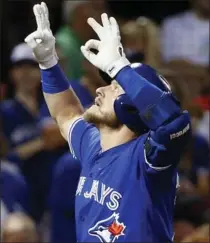  ?? MICHAEL DWYER, THE ASSOCIATED PRESS ?? Toronto Blue Jays’ Josh Donaldson celebrates one of his two solo home runs against the Red Sox at Fenway Park in Boston on Tuesday night.