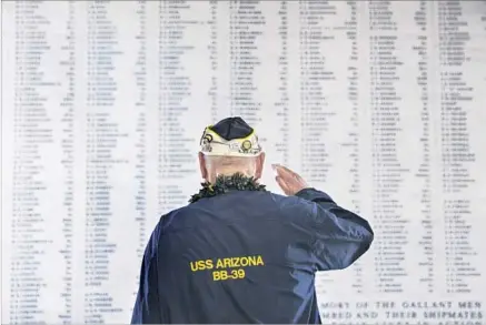  ?? Kent Nishimura Getty Images ?? USS ARIZONA survivor Louis Conter salutes the remembranc­e wall during a memorial service on Dec. 7, 2014.