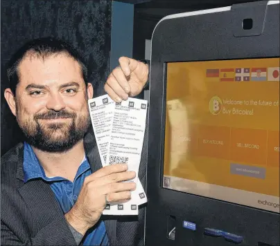  ?? JOE GIBBONS/THE TELEGRAM ?? Ray Bursey, CEO of Ghost Technologi­es, displays cash redeemer vouchers for the shown Bitcoins machine at the Fifth Ticket restaurant/bar on Water Street in St. John’s on Thursday evening.