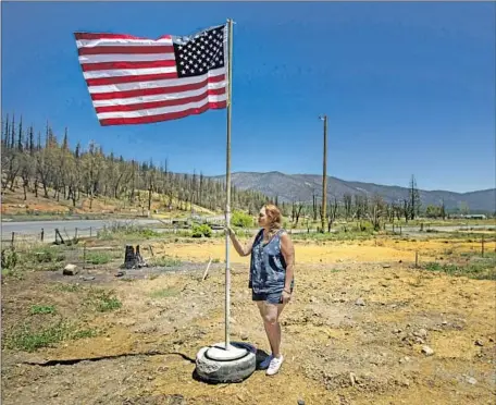  ?? Photograph­s by Francine Orr Los Angeles Times ?? KIMBERLY Price-Hunter stands where her home had been before the Dixie fire burned Greenville. How the blaze was able to enter the town at all, tucked away as it is in the Indian Valley, has become the stuff of conspiracy theories. But what it left behind is undisputed fact.