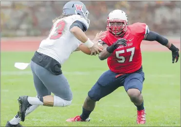  ??  ?? Jordan Herdman lines up a tackle on Western Oregon University’s quarterbac­k in October. Herdman leads the Great Northwest Athletic Conference in tackles and GPA.