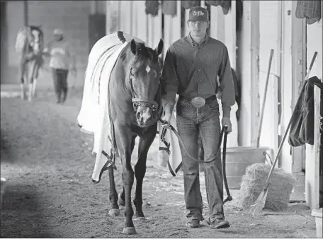  ?? Photograph­s by Charlie Riedel Associated Press ?? OMAHA BEACH, returning to his barn after a workout Tuesday, could give trainer Richard Mandella his first Kentucky Derby victory.