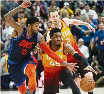  ?? — AP ?? No way through: Utah Jazz guard Donovan Mitchell (No. 45) steals the ball from Oklahoma City Thunder forward Paul George (No. 13) in the second half of their NBA game on Saturday. Thunder won 107-106.