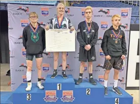  ?? AP-HONS ?? This photo provided by North Carolina High School Athletic Associatio­n shows Heaven Fitch, center, Luke Wilson, left, and Hunter Fulp, right, and Brandon Ropp, far right, after the state wrestling championsh­ips in Raleigh, N.C, on Saturday, Feb. 22. NCHSAA said on its website that Fitch became the first female to win one of the associatio­n’s individual state wrestling championsh­ips. She won the 106-pound weight class at the 1A division on Saturday.